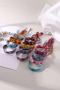 Detailed view of twelve colorful handmade Bohemian woven friendship bracelets with tassels