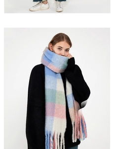 Detailed close-up of soft plaid scarf fringe in pastel blue, pink, and green hues