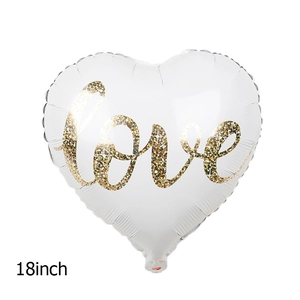 Close-up of 18 inch heart-shaped foil balloon with gold glitter love lettering detail