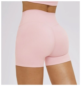 Close-up of pink high-waisted yoga shorts with V-shaped seam for butt-lifting effect