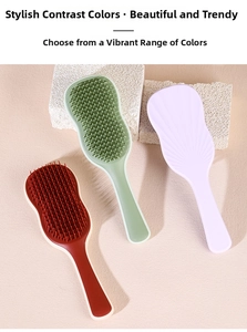 Three ergonomic hairbrushes in sage green, purple, and red on a minimalist stone background