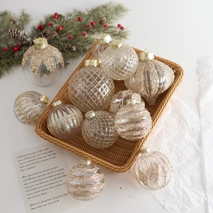 Transparent and gold Christmas ball ornaments set with glitter texture on pine branch