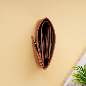 Top view of compact brown leather wallet showing accordion card slots and metal buckle