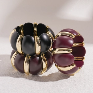 Bold geometric acrylic resin bangle with gold metal accents in black and burgundy