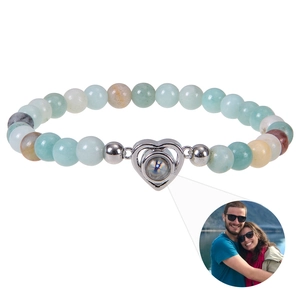 Detail of heart projection bracelet with natural stone beads showing custom photo feature