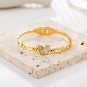 18K gold butterfly cuff bracelet with white shell inlay and zircon accents on stone base