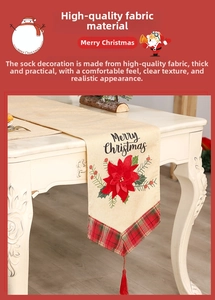 Close-up of Christmas table runner with red poinsettia print and red tassels