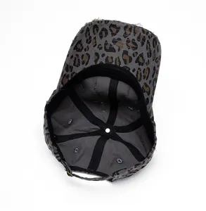 Detail view of the internal structure and distressed lining of leopard print baseball cap