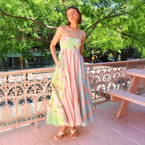 Detail view of colorful patchwork floral dress with thin straps and side pocket