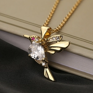 Elegant gold hummingbird pendant necklace with teardrop crystal and pink stones