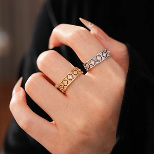 Close-up of vintage hollow flower rings with cubic zirconia in gold and silver finish
