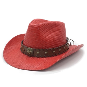 Close-up of red straw cowboy hat with brown leather band and metal star badge detail