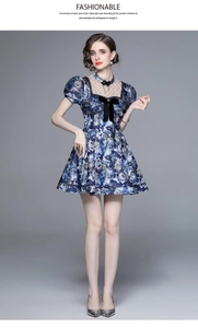 Close-up of vintage floral dress with delicate lace collar and velvet bow details