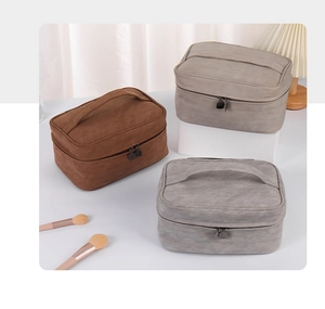 Detail of high-capacity PU suede toiletry bags in brown and grey with dual zippers