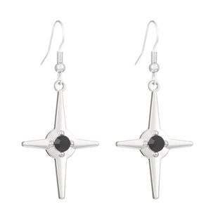 Detail of gothic star drop earrings with polished silver finish and black center stone