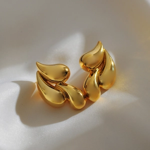 Elegant 18K gold-plated double teardrop brass earrings on white luxury silk background