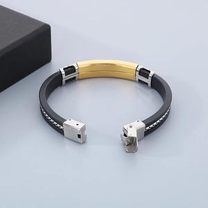 Detail of adjustable black silicone and stainless steel bracelet with fold-over clasp