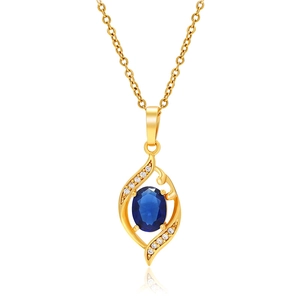 Macro shot of gold-plated necklace with oval blue gemstone and white zircon leaves