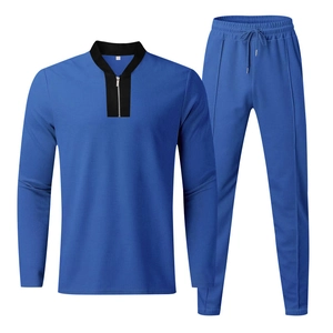 Detailed view of men's blue tracksuit with waffle knit texture and quarter-zip collar
