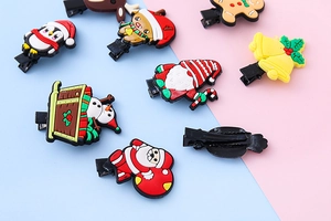 Close-up of colorful Christmas themed hair clips with PVC cartoon motifs and metal duckbill clips