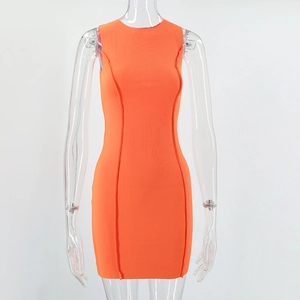 Close-up of orange sleeveless knit dress showing ribbed texture and vertical seams