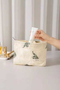 Close-up of cotton linen embroidery cosmetic bag with delicate leaf pattern details