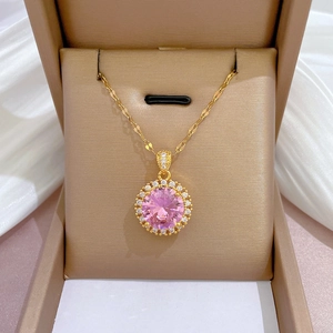 Detail of pink crystal pendant with sparkling zircons in a beige jewelry gift box