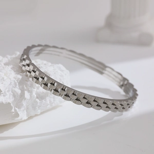 Detailed macro view of silver stainless steel triple-row watchband style bracelet texture