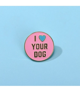 Detail of pink enamel round brooch with I LOVE YOUR DOG text and gold metal trim