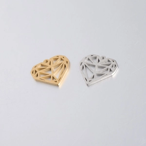 Detail of hollow heart-shaped pendants in gold and silver finishes for jewelry making