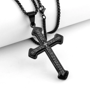 Detail of black stainless steel cross pendant featuring engraved Lord's Prayer text