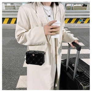 Chic black PVC quilted crossbody bag with metal chain strap in urban street style