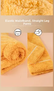 Detail view of yellow fleece trousers featuring elastic waistband and straight leg design