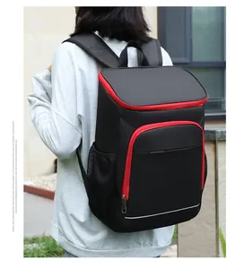 Close-up of a large black insulated backpack with red zippers for outdoor camping and hiking