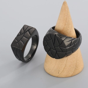 Macro shot of black titanium steel rings featuring unique geometric cracked texture details