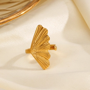 Elegant gold ginkgo leaf open ring in stainless steel on a soft silk background