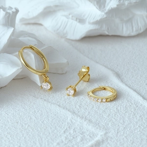 Detail view of 925 silver gold-plated Evil Eye earring set with zircon on white plaster