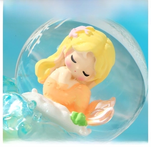 Detailed close-up of a cartoon mermaid crystal ball with coral and cloud base decor