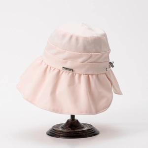 Detailed view of pink sun hat with ruffled brim and adjustable drawstring buckle
