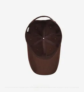 Detail view of the cotton dark brown baseball cap inner structure and 6-panel stitching