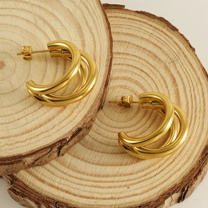 Minimalist 18K gold plated multi-layer overlapping stud earrings for women on wood base