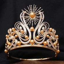 Detail einer goldenen Barockkrone mit Sonnenstrahlenmuster und eleganten weißen Perlen