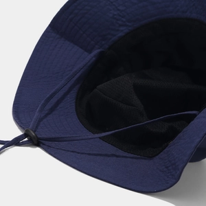 Detail view of navy blue sun hat showing breathable mesh lining and windproof drawstring