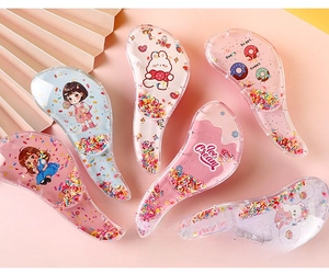 Detail of transparent detangling hair combs with colorful sequins and cute cartoon patterns