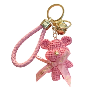 Pink resin bear keychain with woven texture, leather strap and eternal love ribbon