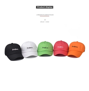 Flat lay detail showing a set of five colorful cotton baseball caps with Project embroidery