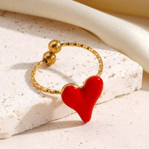 Minimalist gold stainless steel ring featuring a vibrant red enamel heart and quilted texture