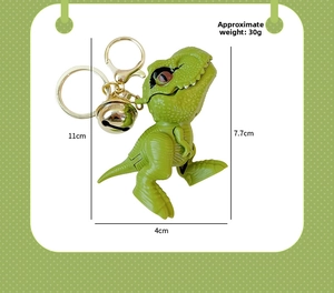 Detail view of a green dinosaur keychain with bell and lobster clasp, height 11cm
