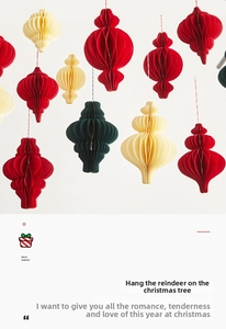 Close-up of honeycomb paper Christmas lanterns in red, cream, and dark green colors