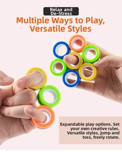 Close-up of hands rotating colorful magnetic rings in orange yellow green and blue